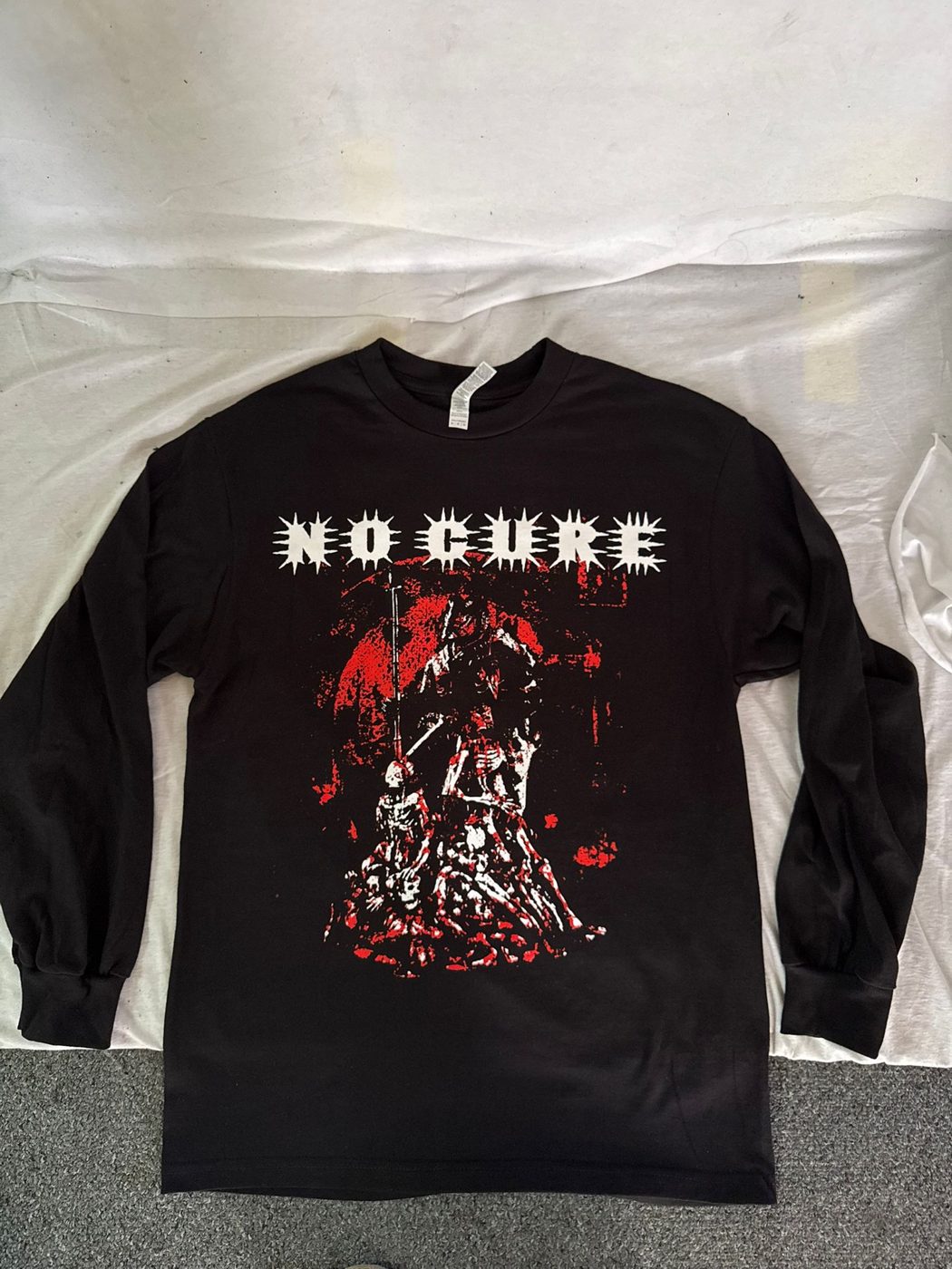 Black long sleeve tee with a detailed red and white No Cure print by Ray's Print